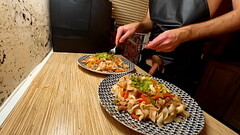 Sexy cooking. Naked gay chef is cooking rice noodle with chicken and vegetables Thumb