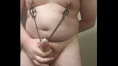 Fat boy with nipple clamps on masturbates into a condom and cums 3 times Thumb