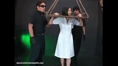 Horny Asian Submissive Bound In Wooden Stocks And Dominated Thumb