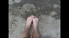 Naked Driver pisses on his feet on the bank of the South Skunk River Thumb