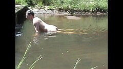 Cumming on a stone in a river Thumb