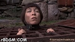 Tied up girl waits with fear for her next hot t. Thumb