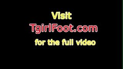 Barefoot ebony tranny puts lotion on her feet Thumb